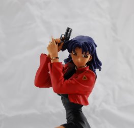 Misato with handgun on knees
